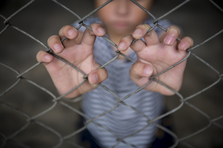 The Asian girl child holding the cage was imprisoned make no freedom or lack of freedomの写真素材