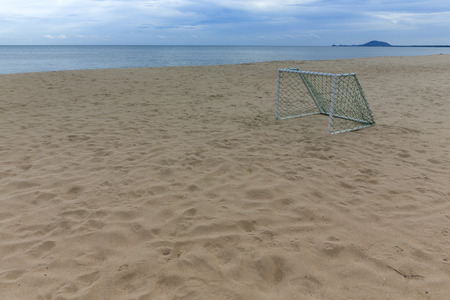Soccer goal on beach with cloud and blue skyの写真素材
