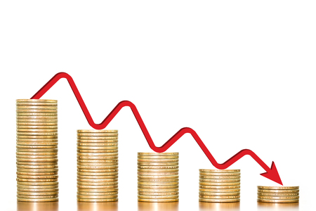 Stack of money coins arranged as a graph on wooden table with red arrow indicates economic downturn on white background, concept of business and finance downturnの写真素材