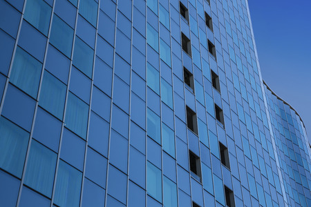 Close up of a modern office with blue sky background - glass building exteriorの写真素材