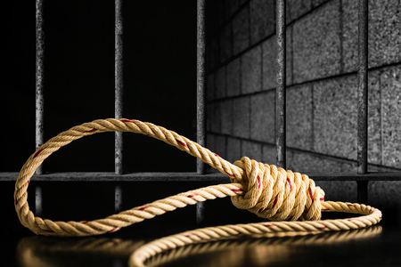 Brown rope noose dark and light on black table with old prison bars cell lock background dark black and lightの写真素材