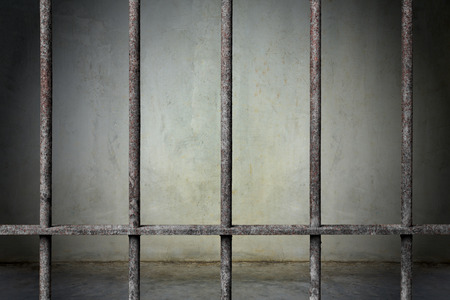 Old prison rusted metal bars cell lock with dark and bright in the jail, concept of strengthen and...