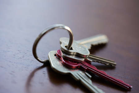 Set of house keys and keyring sitting on a table