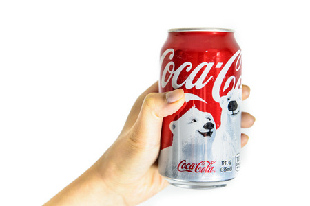 BOSTON, USA â€“ DECEMBER 28, 2013: Photo of a Coca-Cola can held with a hand. Coca-Cola was...