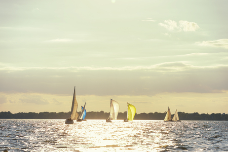 Sailboat on a lake as the sun setsの写真素材