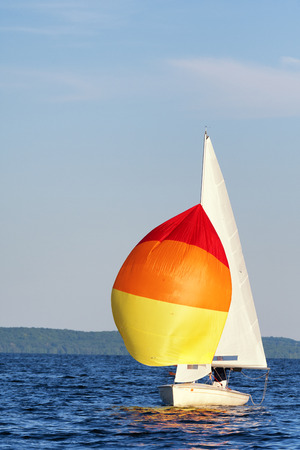 A flying scot sail boat with it's spinnaker up.の写真素材