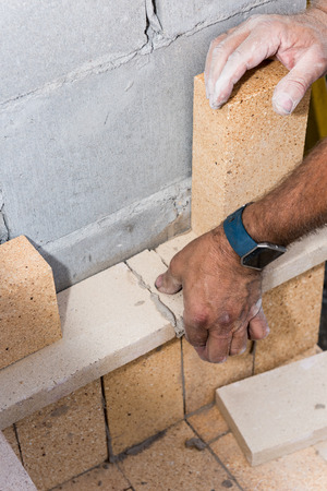Bricks designed for fires is being layed down for an outdoor cooking areaの写真素材
