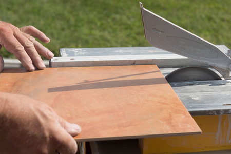 Tile being cut on a wet saw for that perfect fit.