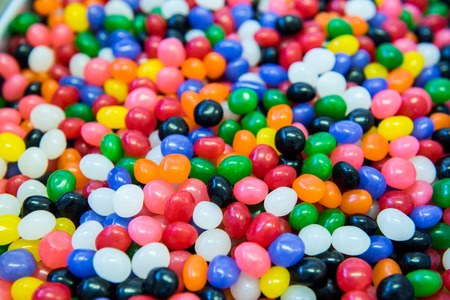A close up shot of a lot of jelly beans in a large containerの写真素材