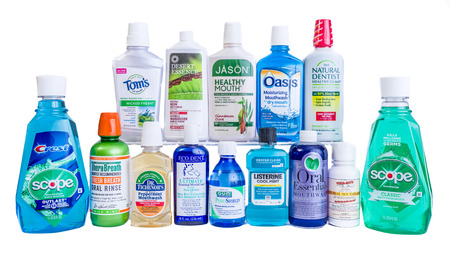 Winneconne, WI - 11 May 2018:  A collection of some of most popular mouthwash including, Listerine, Scope, Crest, Natural Dentist, and Thera Breath on an isolated backgroundのeditorial素材