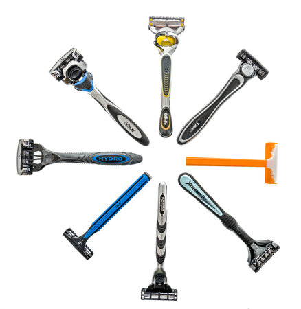 Winneconne, WI - 4 July 2018: A collection of different brands disposable shaving razors including...
