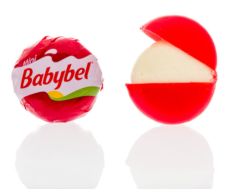 Winneconne, WI - 30 July 2018: A single Babybel semisoft cheese in original flavor on an isolated backgroundのeditorial素材