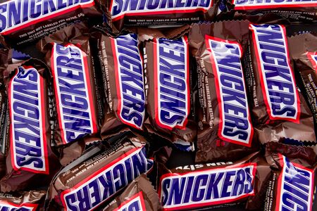 Winneconne, WI -  12 April 2019: A close-up of Snickers candy bars on an isolated backgroundのeditorial素材
