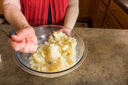 Making mashed potatoes from the start to finish in a glass bowlの写真素材