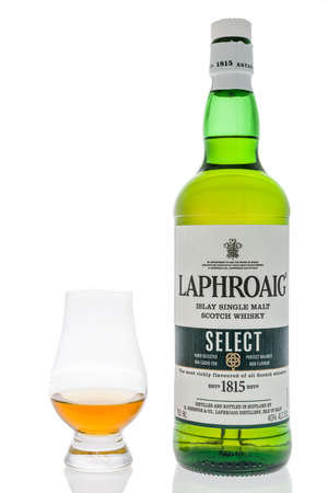 Winneconne,  WI - 12 April 2020:  A bottle of Laphroig single malt Scotch  whiskey select with a Glencairn glass on an isolated background.のeditorial素材