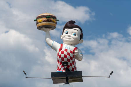 Manistique, MI - 9 July 2020: A Big Boy mascot holding its famous hamburger that made the franchise famous.のeditorial素材