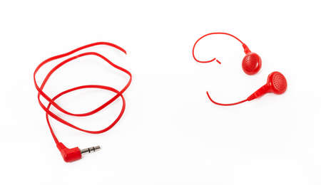 Headphones on a white background. Torn headphones. Repair of electronic devices. Broken wire.