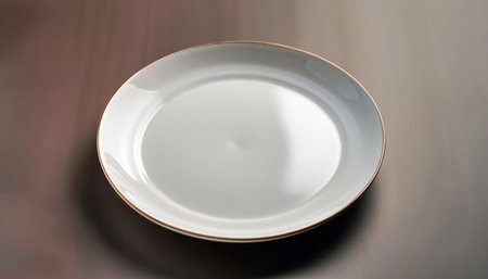Empty white plate on the table, close-up, top view