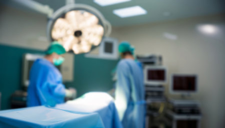 Blurred background of two surgical surgeons in operating room with surgery equipment.