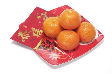 Red Packet and Mandarins on Red Plateの写真素材