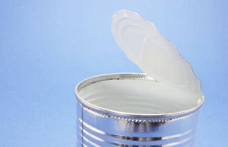 Empty tin can on blue background