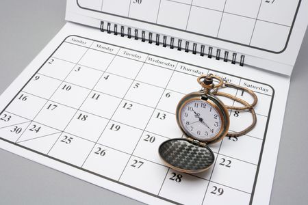 Pocket Watch on Calendar with Grey Backgroundの写真素材