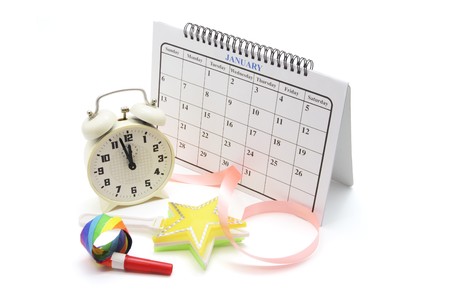 Calendar, Alarm Clock and Party Favors on White Backgroundの写真素材