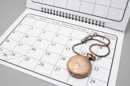 Pocket Watch on Calendar with Grey Backgroundの写真素材