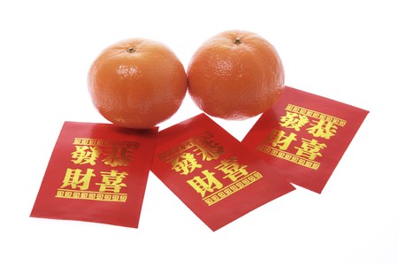 Mandarins and Red Packets on White Backgroundの写真素材