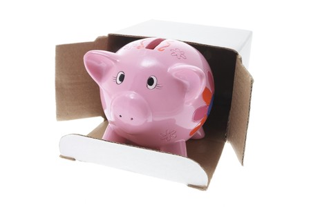 Piggybank in Cardboard Box on White Backgroundの写真素材