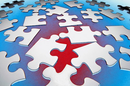 Jigsaw Puzzle Pieces on Red and Blue Backgroundの写真素材