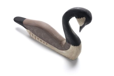 Wooden Goose Figurine on Isolated White Backgroundの写真素材
