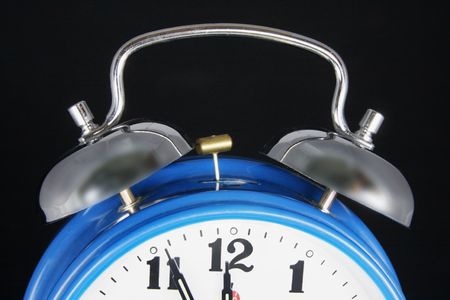 Close Up of Alarm Clock on Black Backgroundの写真素材