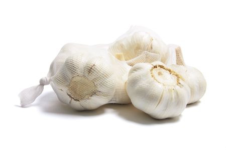 Garlic in Mesh Bag on White Backgroundの写真素材