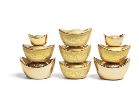 Stacks of Chinese Gold Nuggets on White Backgroundの写真素材