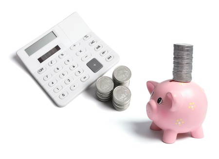 Calculator and Coins on White Backgroundの写真素材