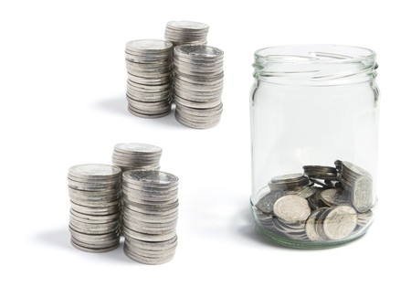 Coins in Glass Jar on White Background