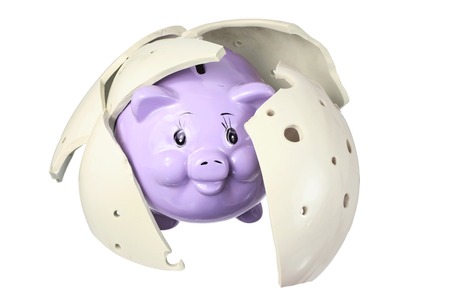 Piggybank and Broken Pieces on White Backgroundの写真素材