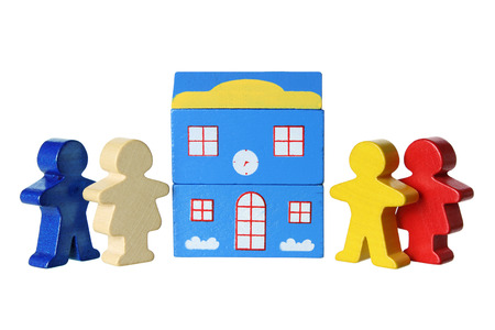 Wooden Figures and Building on White Backgroundの写真素材