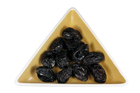 Prune on Dish with White Backgroundの写真素材