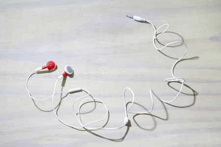 Earphone on Wooden Backgroundの写真素材