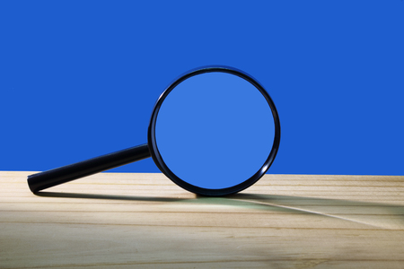 Magnifying Glass on Wooden Backgroundの写真素材