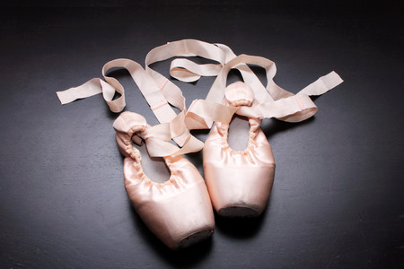 Ballet Shoes on Wooden Backgroundの写真素材