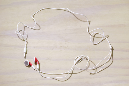 Earphone on Wooden Backgroundの写真素材