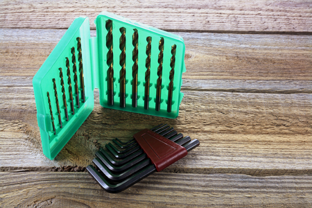 Drill Bit Set and Alllen Keys on Wooden Backgroundの写真素材
