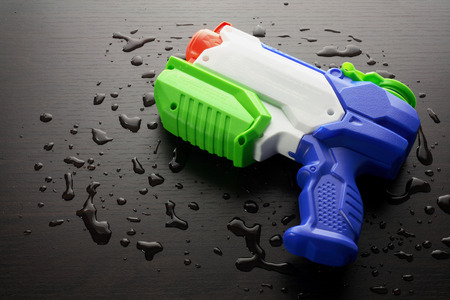 Water Pistol on Wooden Backgroundの写真素材