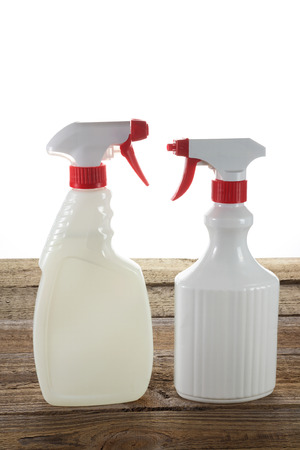 Spray Bottles on Wooden Backgroundの写真素材