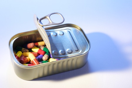 Pills in Tin Can on Seamless Backgroundの写真素材