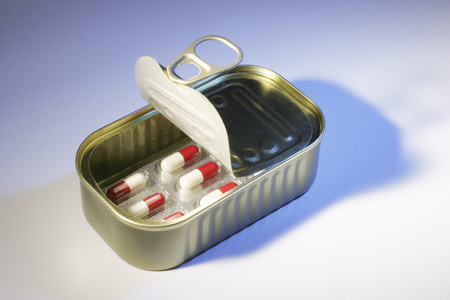 Pills in Tin Can on Seamless Backgroundの写真素材