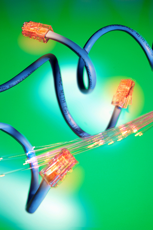 Network Cable and OPtical Fibres on Green Backgroundの写真素材
